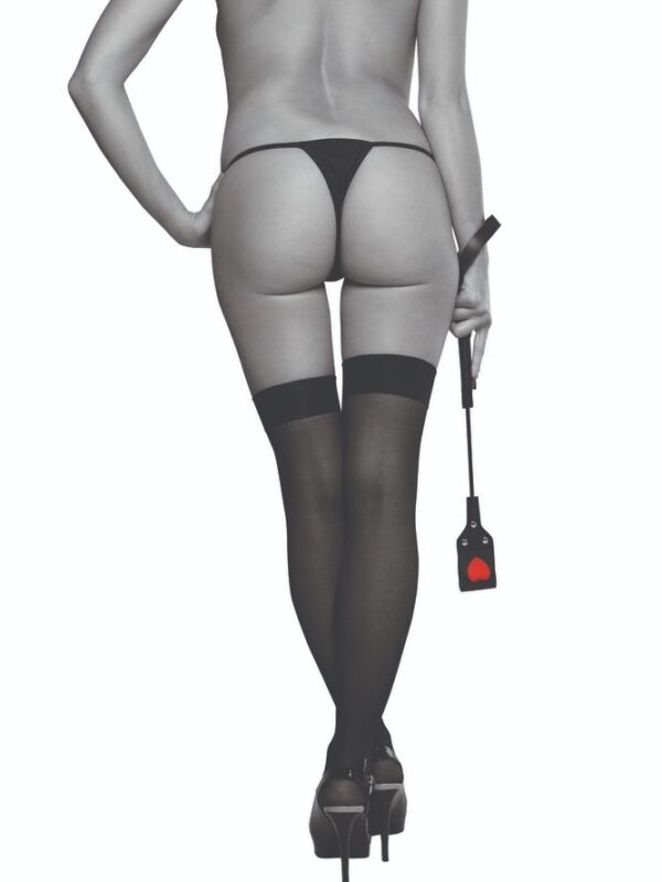 Model in black stockings holding the heart impression riding crop at her side