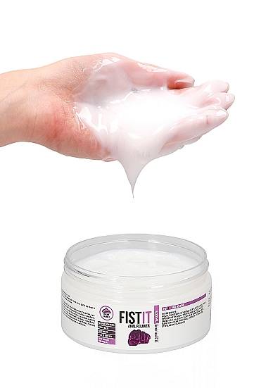 Hand scooping Fist It Anal Relaxer gel from the open jar