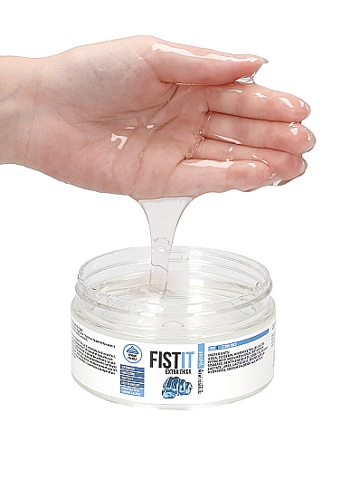 Hand scooping thick clear gel from the Fist It Extra Thick jar