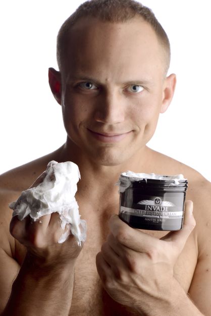 Model holding an open jar of Invade deep fisting cream