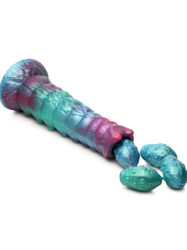 Galactic Breeder ovipositor on its side with 4 silicone eggs spilling from the tip