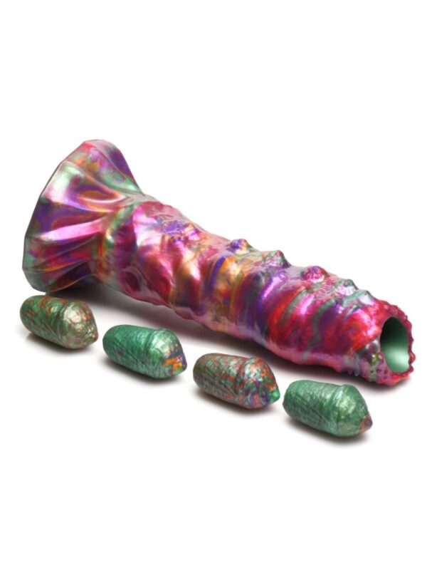 Larva ovipositor dildo lying beside its 4 green silicone eggs