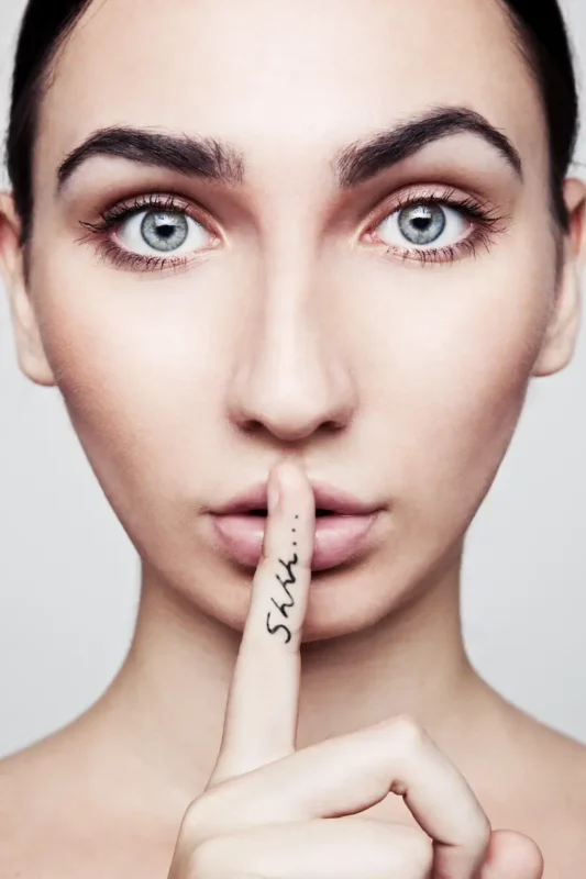 Discreet shipping - woman holding a finger to her lips
