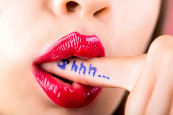 Discreet sex toy shopping - red lips with Shhh written on a finger