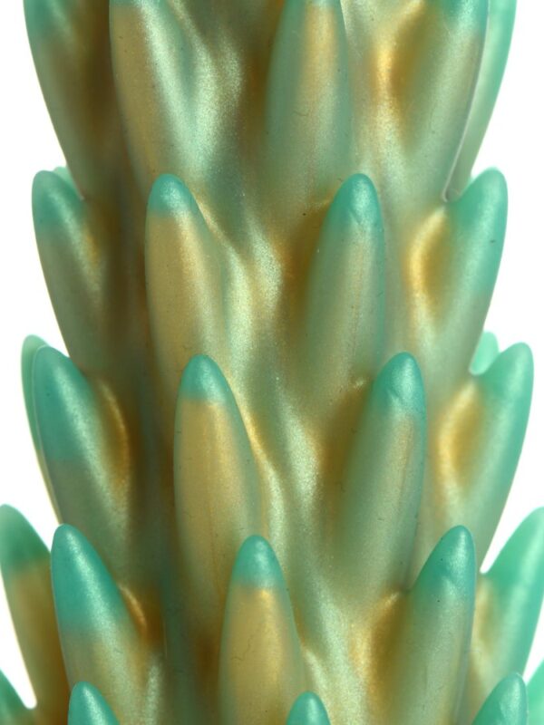 Close-up of the soft, rounded gold and teal silicone spikes