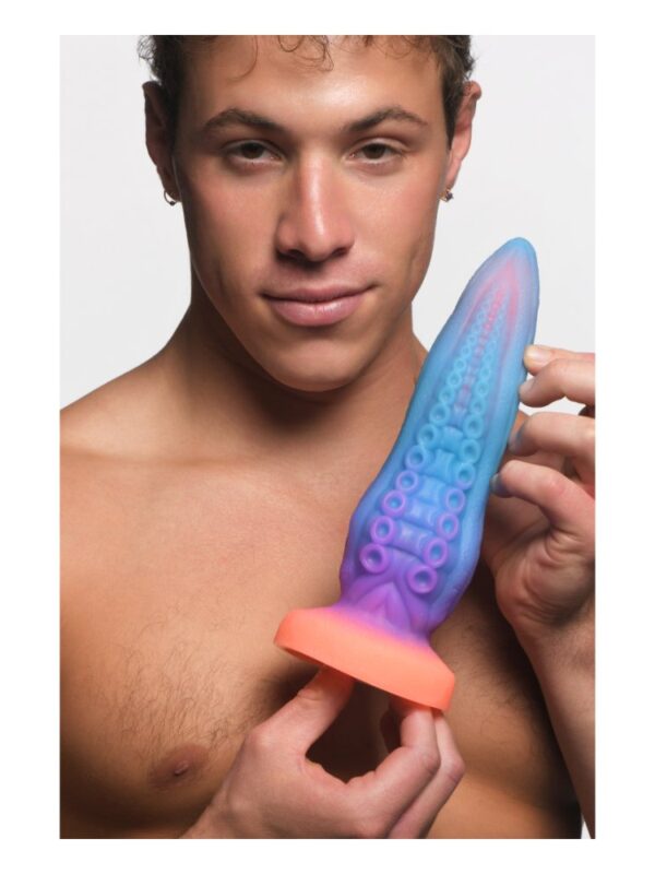 Man holding the Tenta-Cock tentacle dildo to show its size